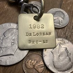 1982 De Lorean DMC-12 Brass Key Fob New. Price: $16.95.